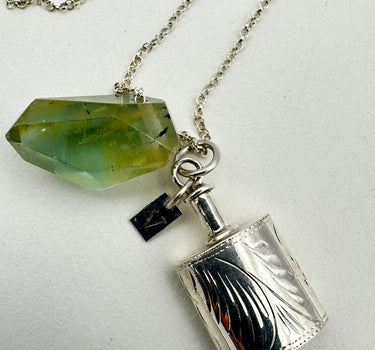 Antique carved silver perfume bottle with green morganite